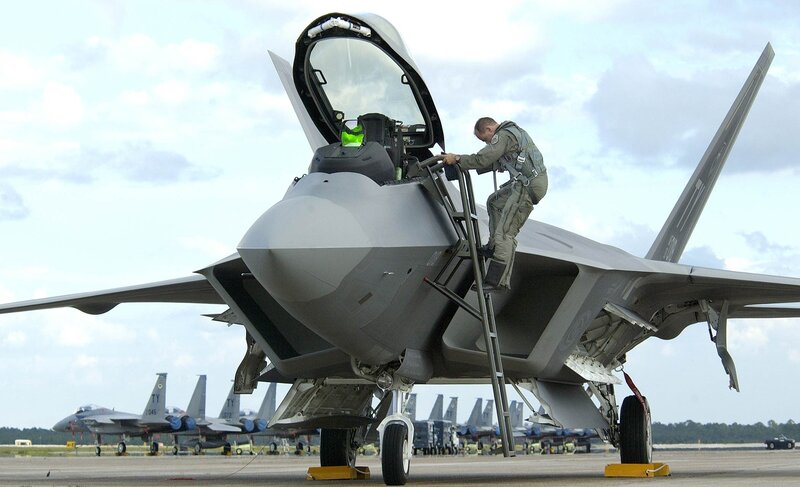 Airman boarding fighter jet