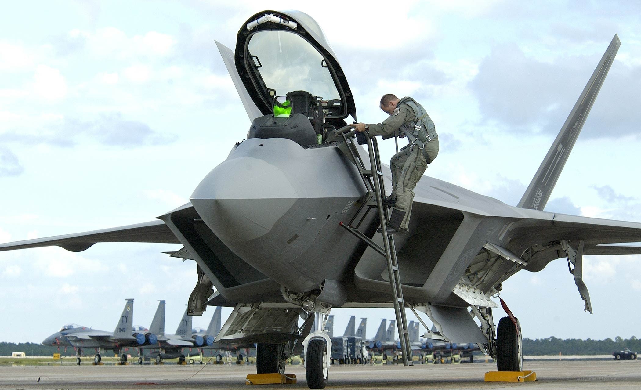 Airman boarding fighter jet