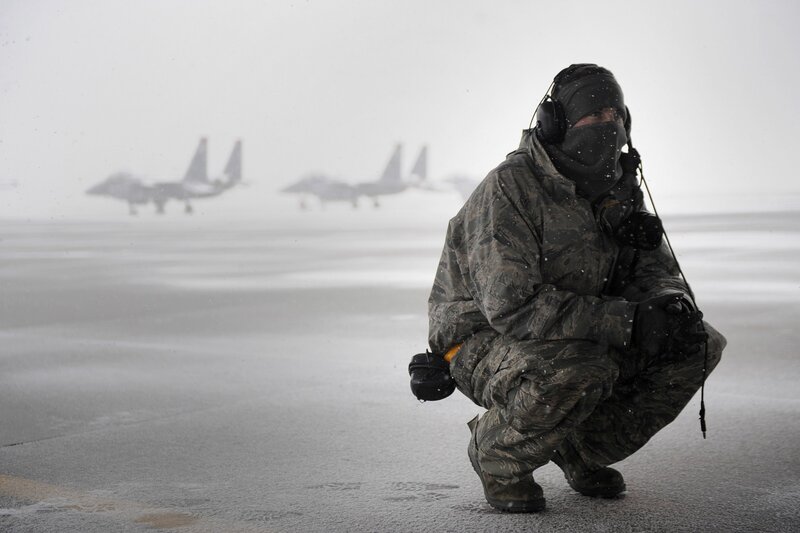 Airman in snowstorm with jets