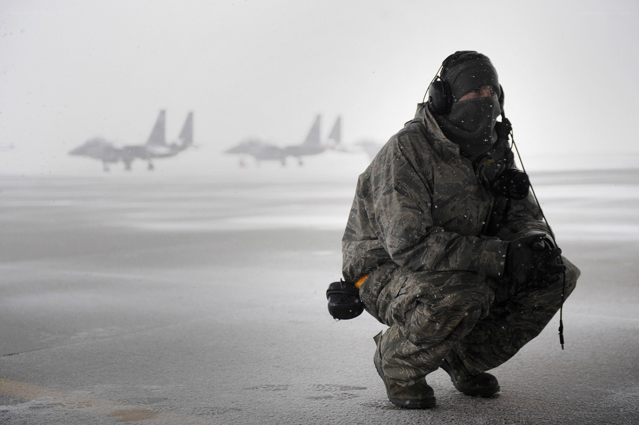 Airman in snowstorm with jets