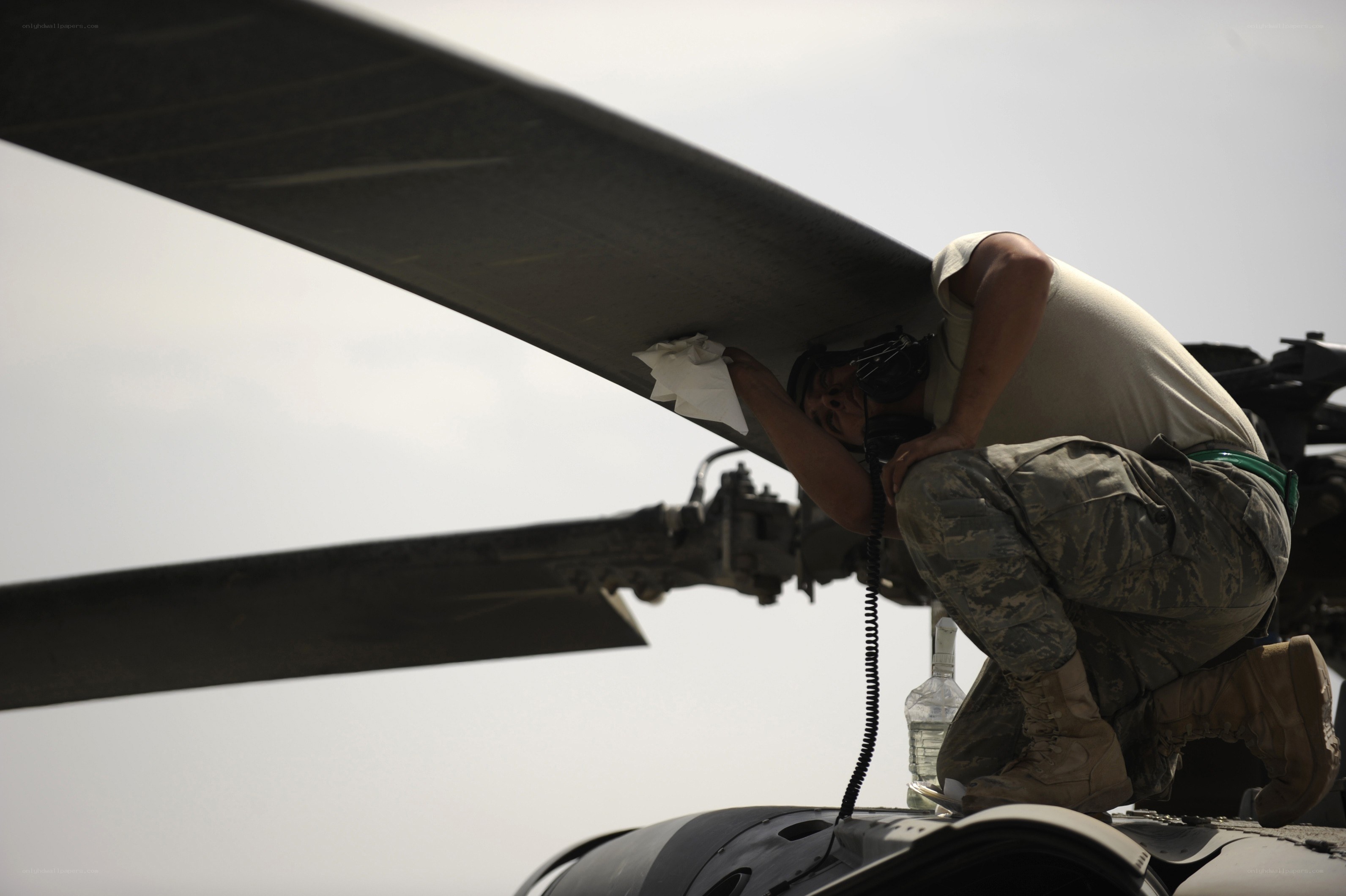 Airman servicing helicopter rotor