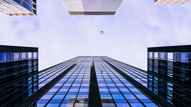 Airplane Above Skyscrapers