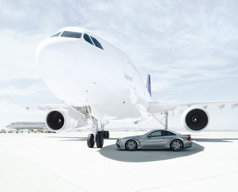 Airplane and luxury car on tarmac