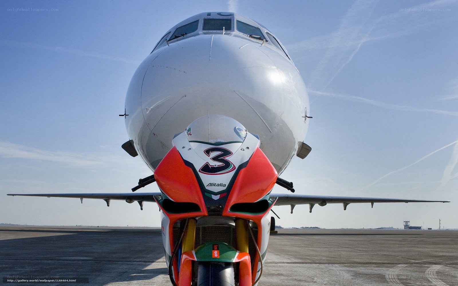 Airplane and motorcycle on tarmac