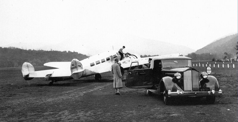 Airplane and vintage car on airfield
