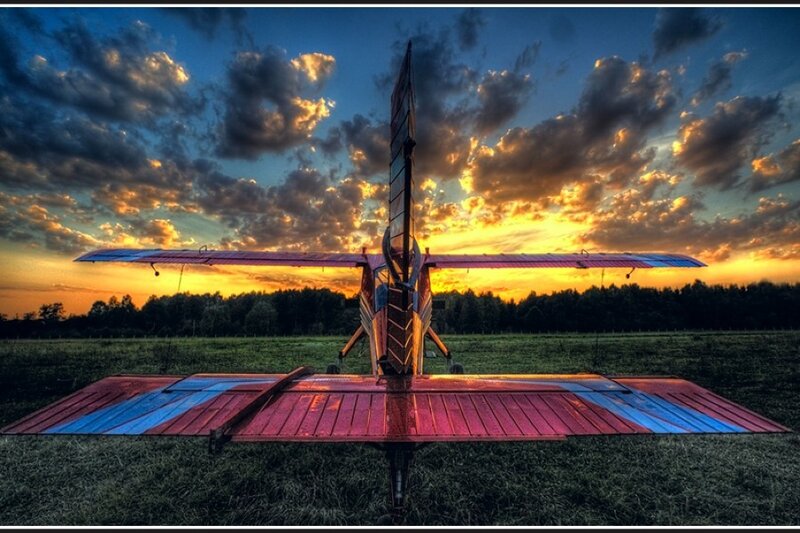 Airplane at sunset on a field