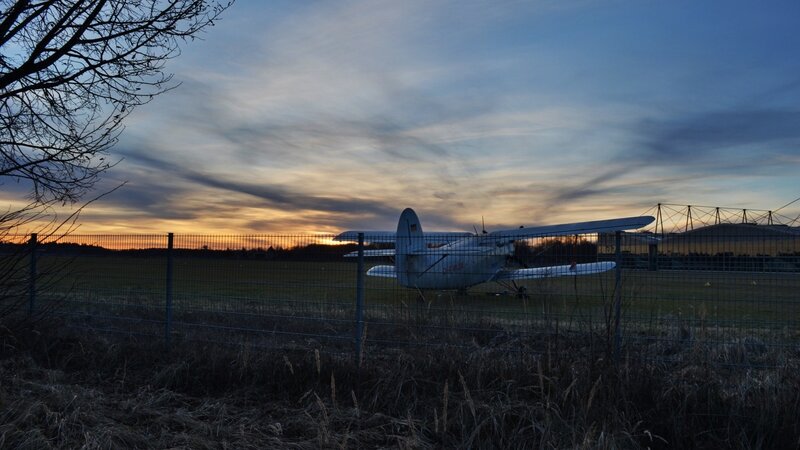 Airplane at sunset on airfield