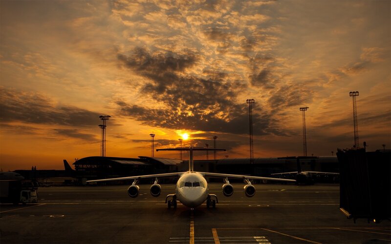 Airplane at sunset on tarmac