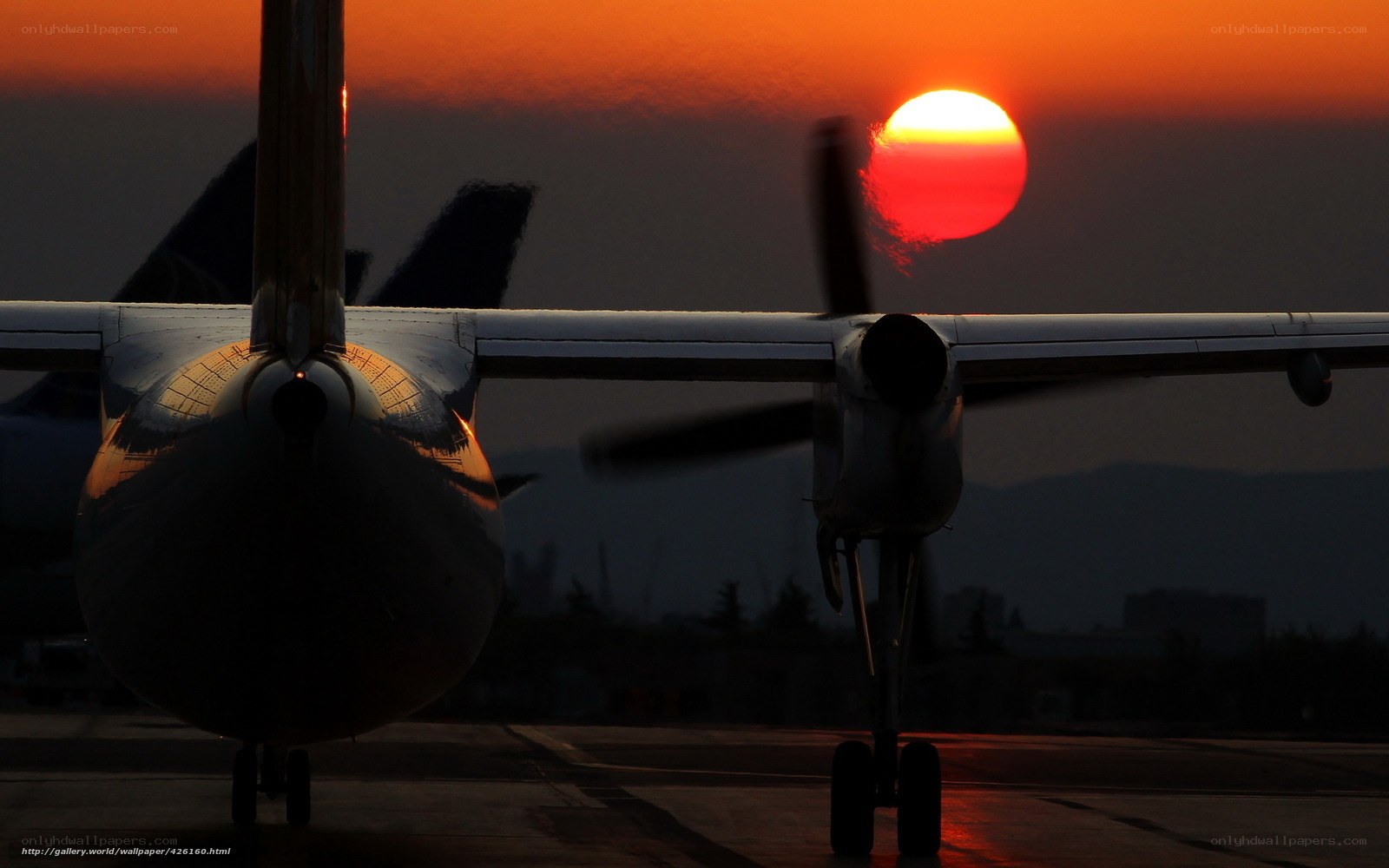 Airplane at sunset on tarmac
