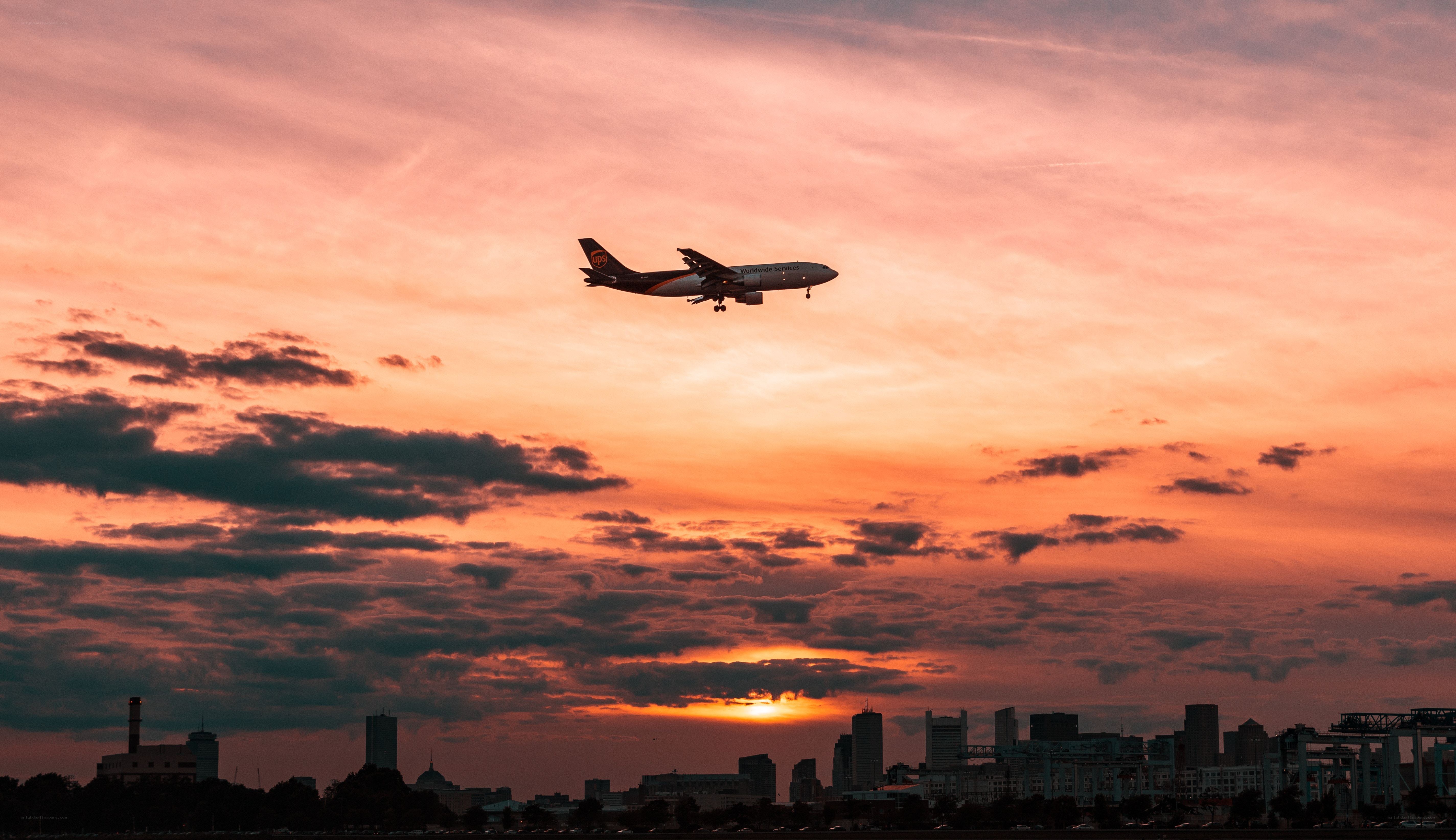 Airplane at sunset over city