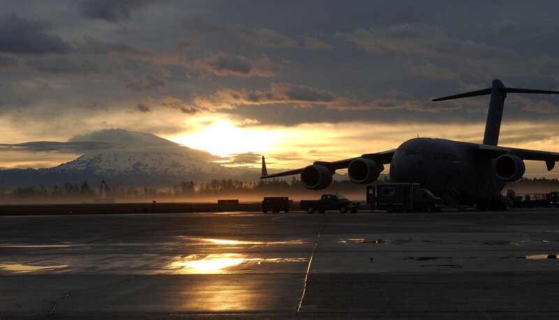 Airplane at sunset with mountain