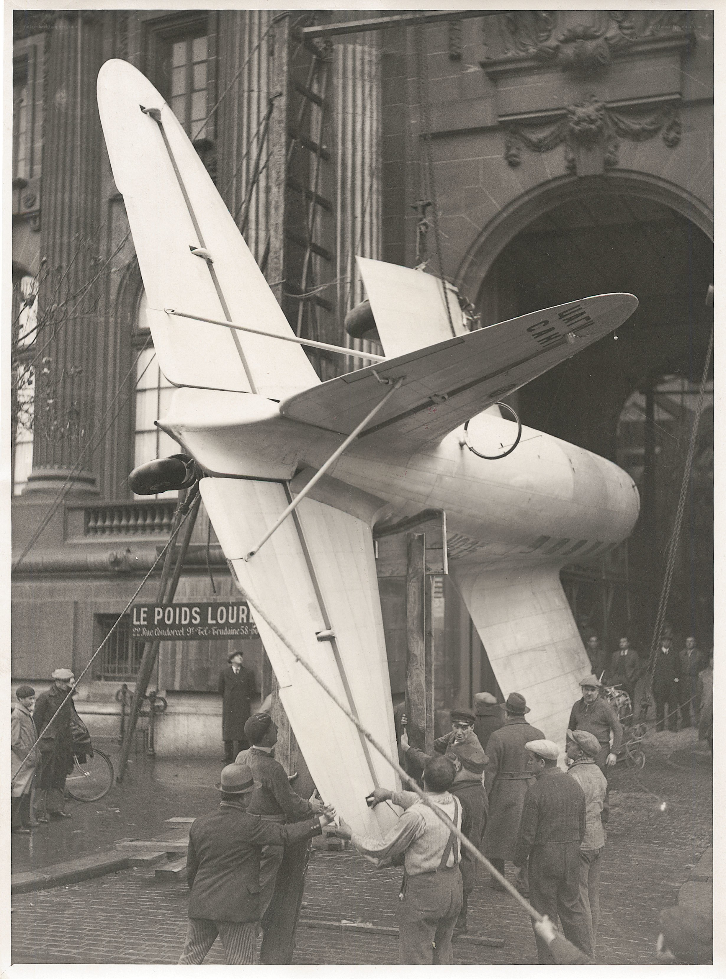 Airplane being lifted by crane