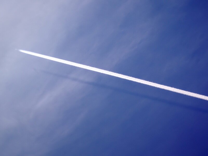 Airplane contrail in blue sky