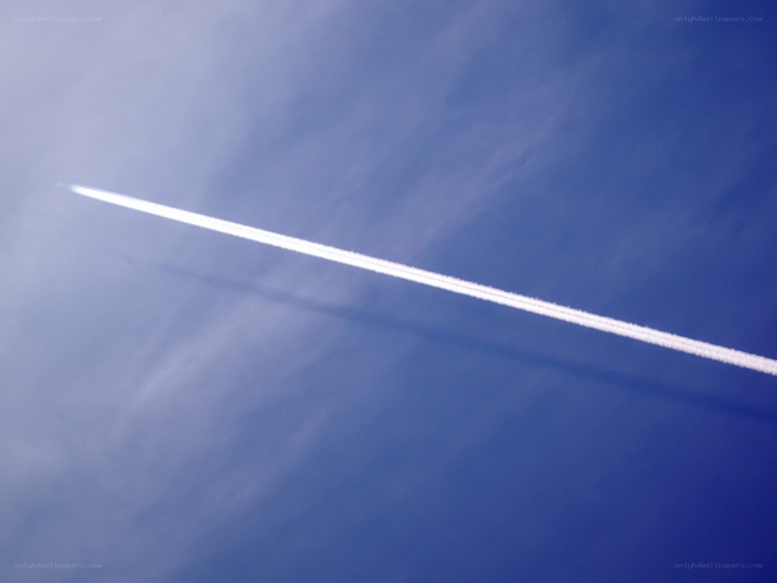Airplane contrail in blue sky