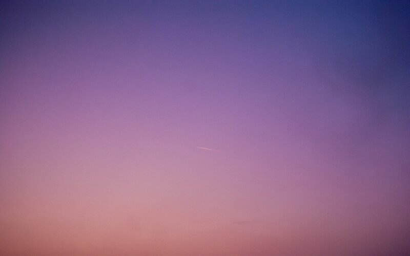 Airplane Contrail in Sky — Purple