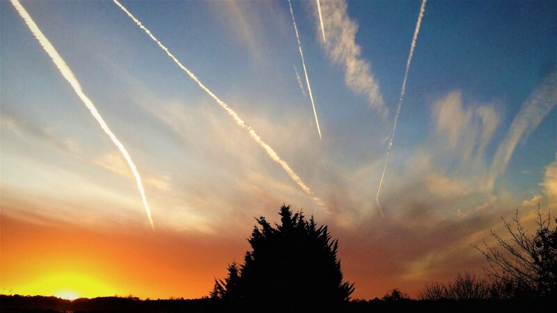 Airplane Contrails at Sunset — Orange