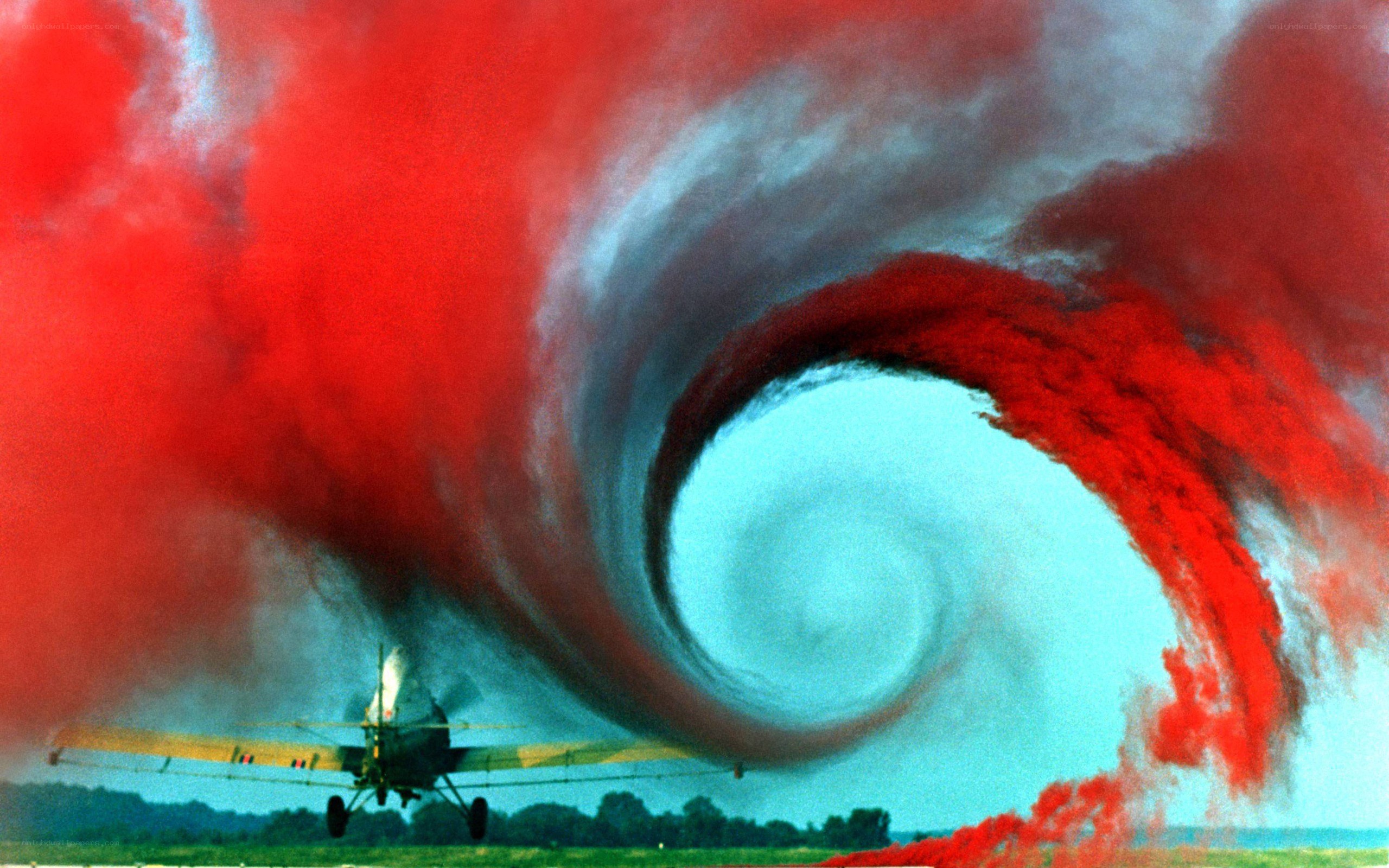 Airplane creating red smoke swirl