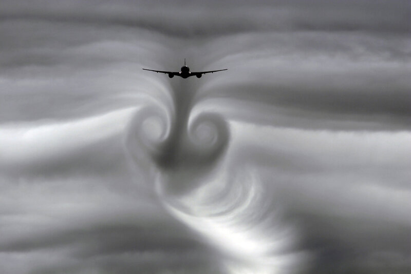 Airplane creating wingtip vortices