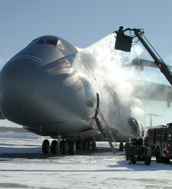 Airplane de-icing on snowy tarmac