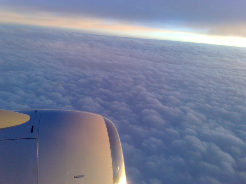 Airplane Engine Above Clouds