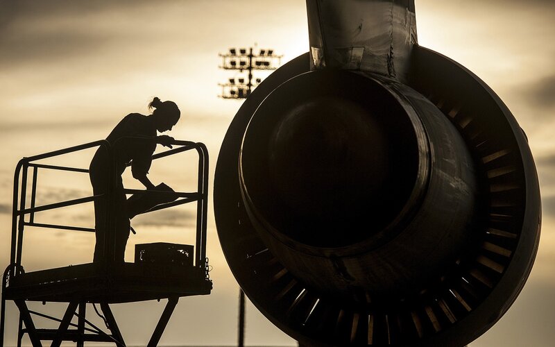 Airplane engine maintenance at dusk