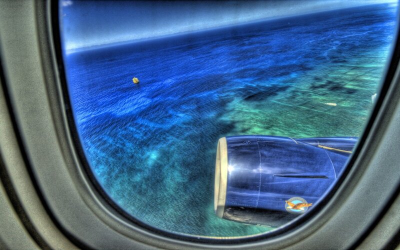 Airplane Engine over Ocean — Blue