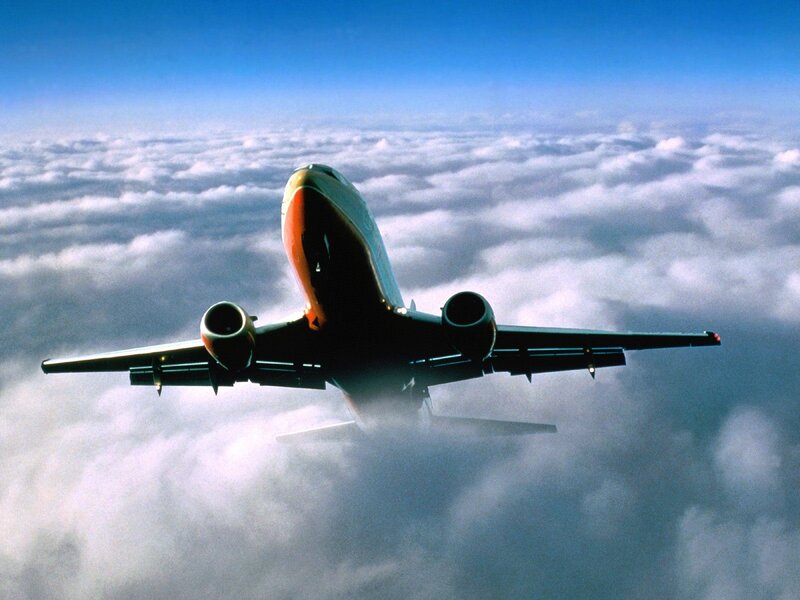 airplane flying above clouds