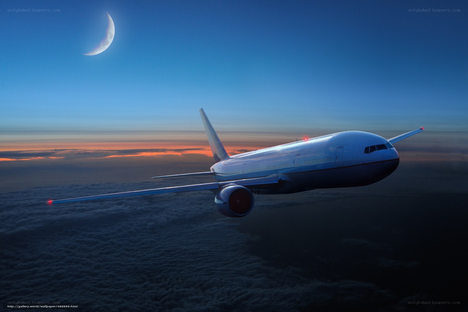 Airplane flying above clouds at dusk