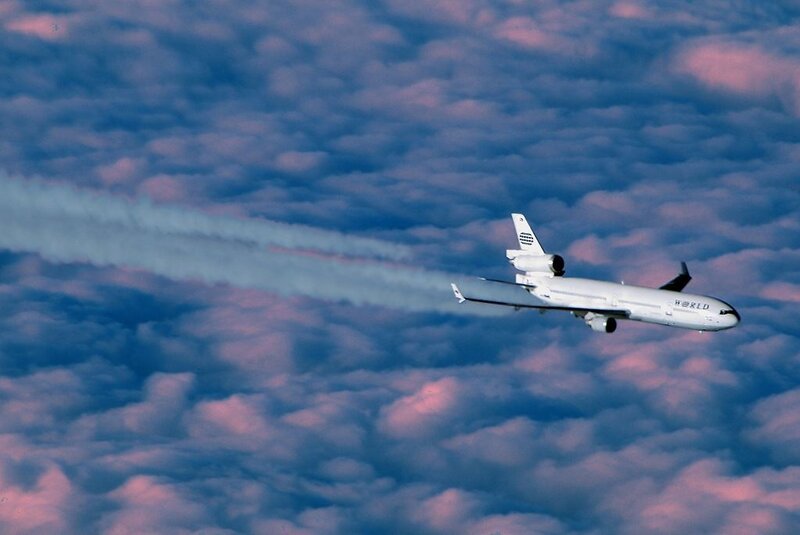 Airplane Flying Above Clouds — Blue