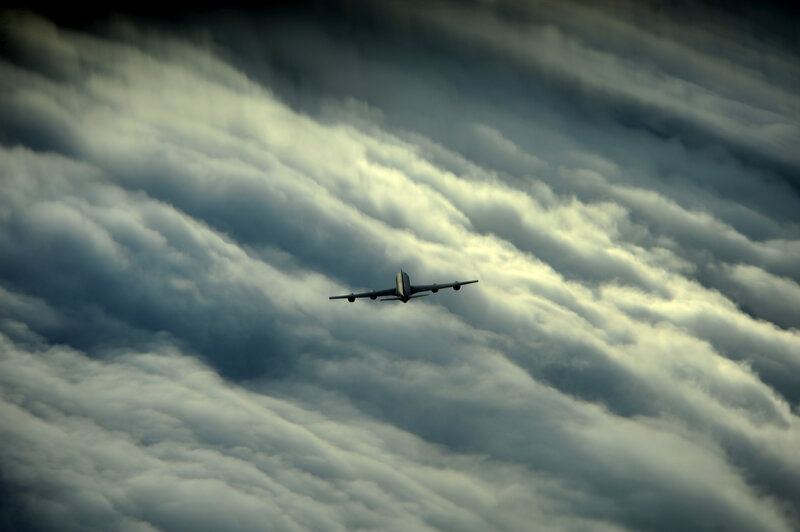 Airplane Flying Above Clouds — Gray