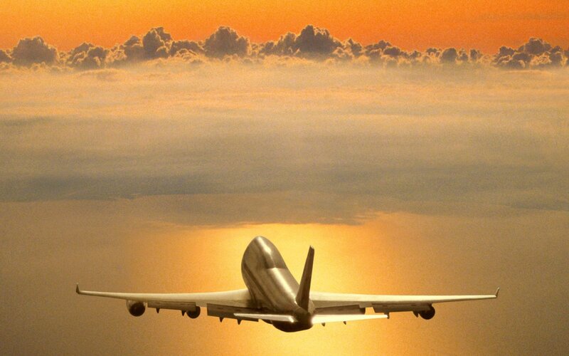 Airplane Flying Above Clouds — Orange, Serene, Sunset