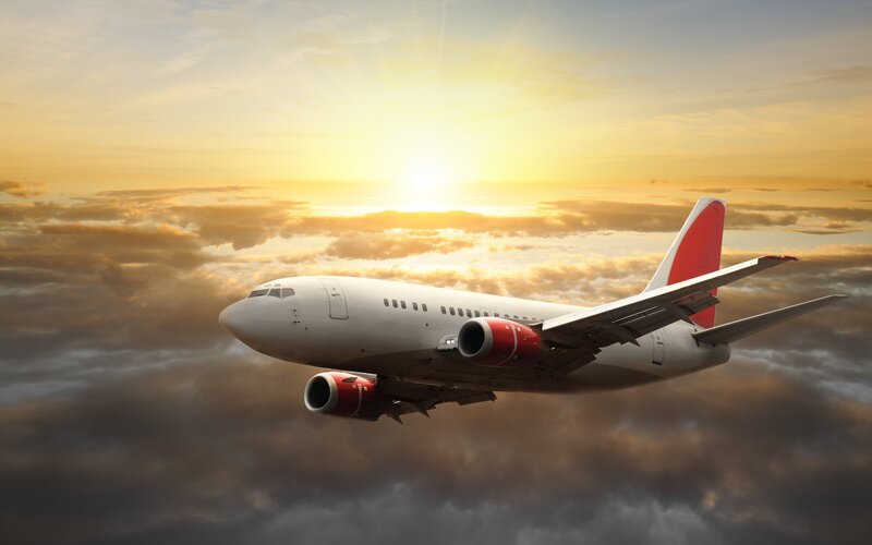 Airplane Flying Above Clouds — White, Dramatic, Sunset