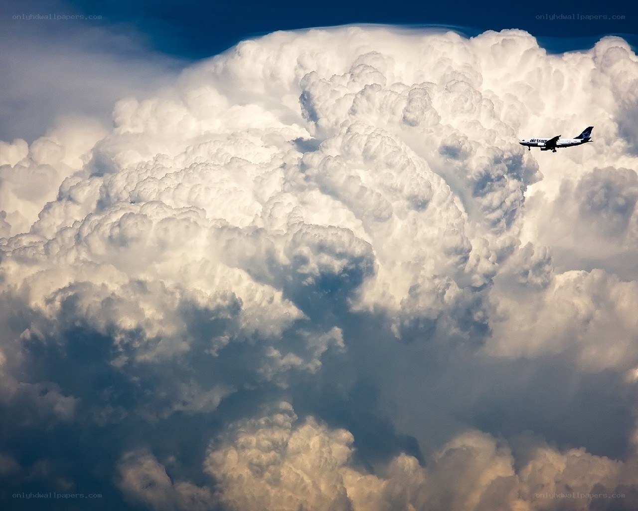 Airplane flying above storm clouds
