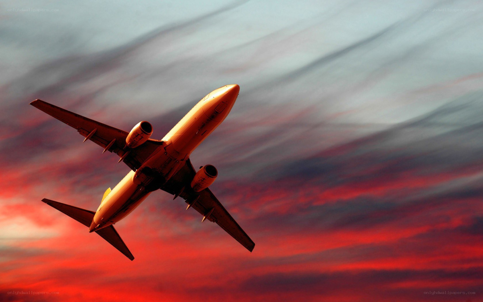 Airplane flying at sunset