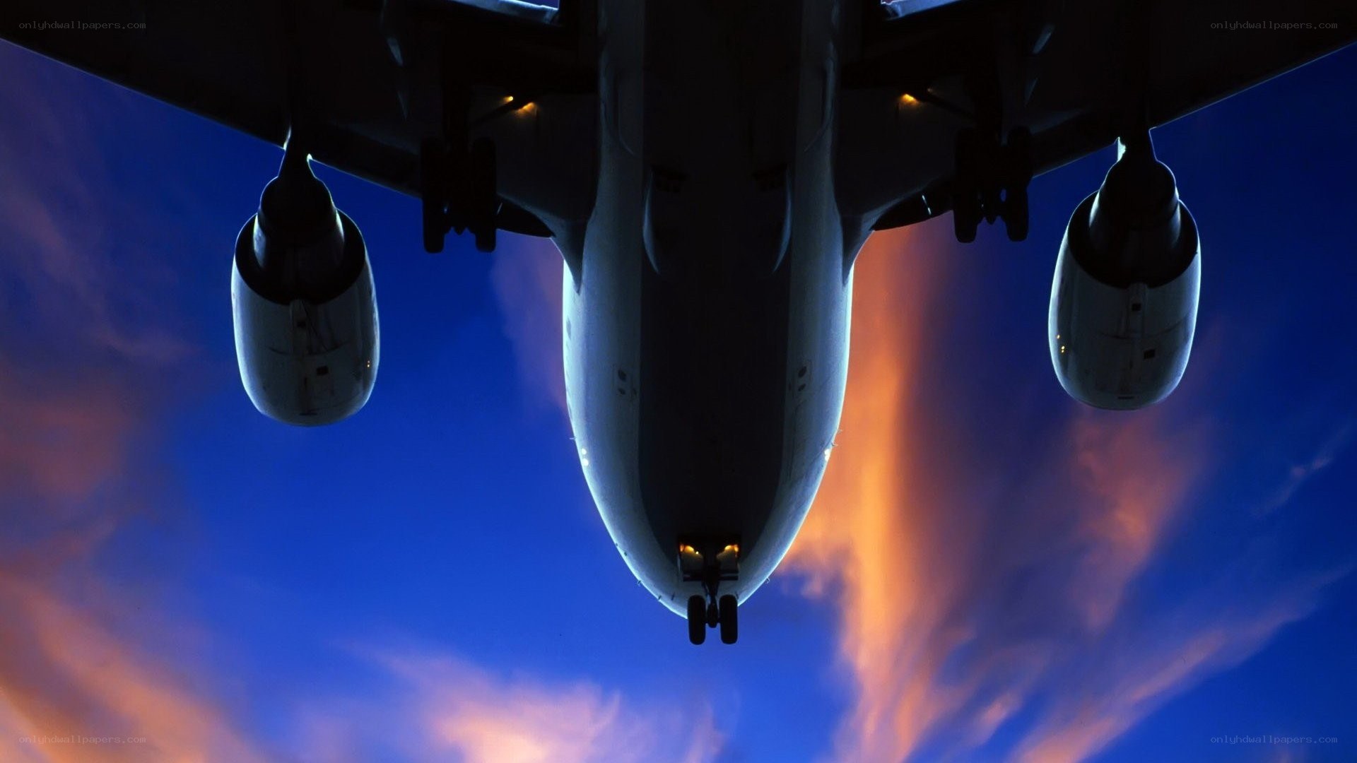 Airplane flying at sunset