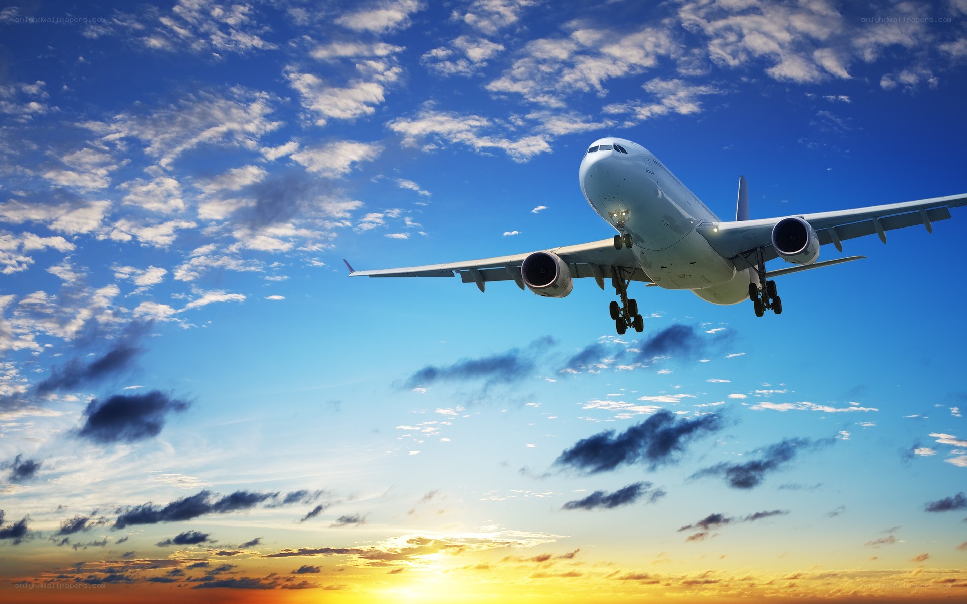 Airplane flying at sunset