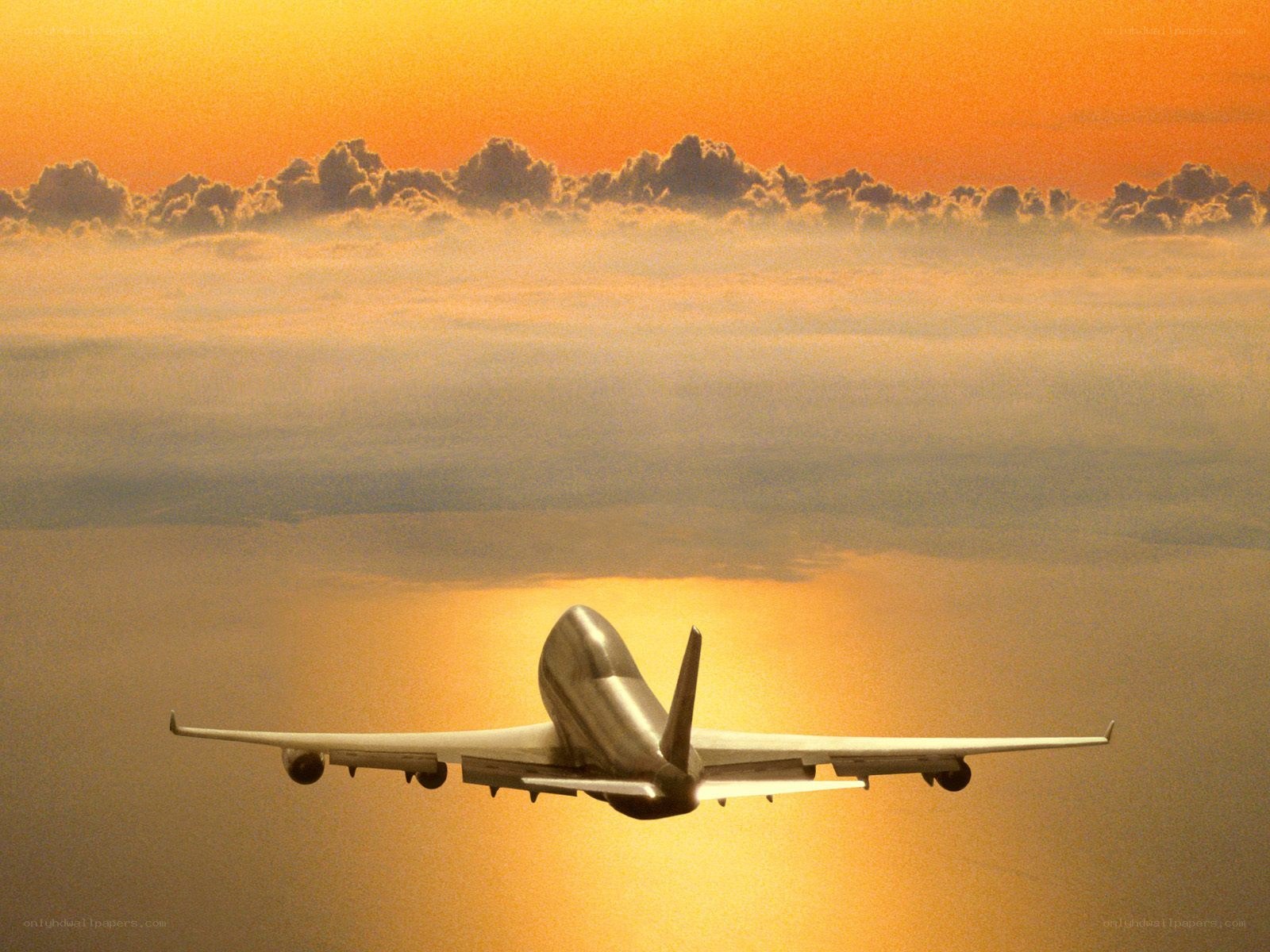 Airplane flying at sunset