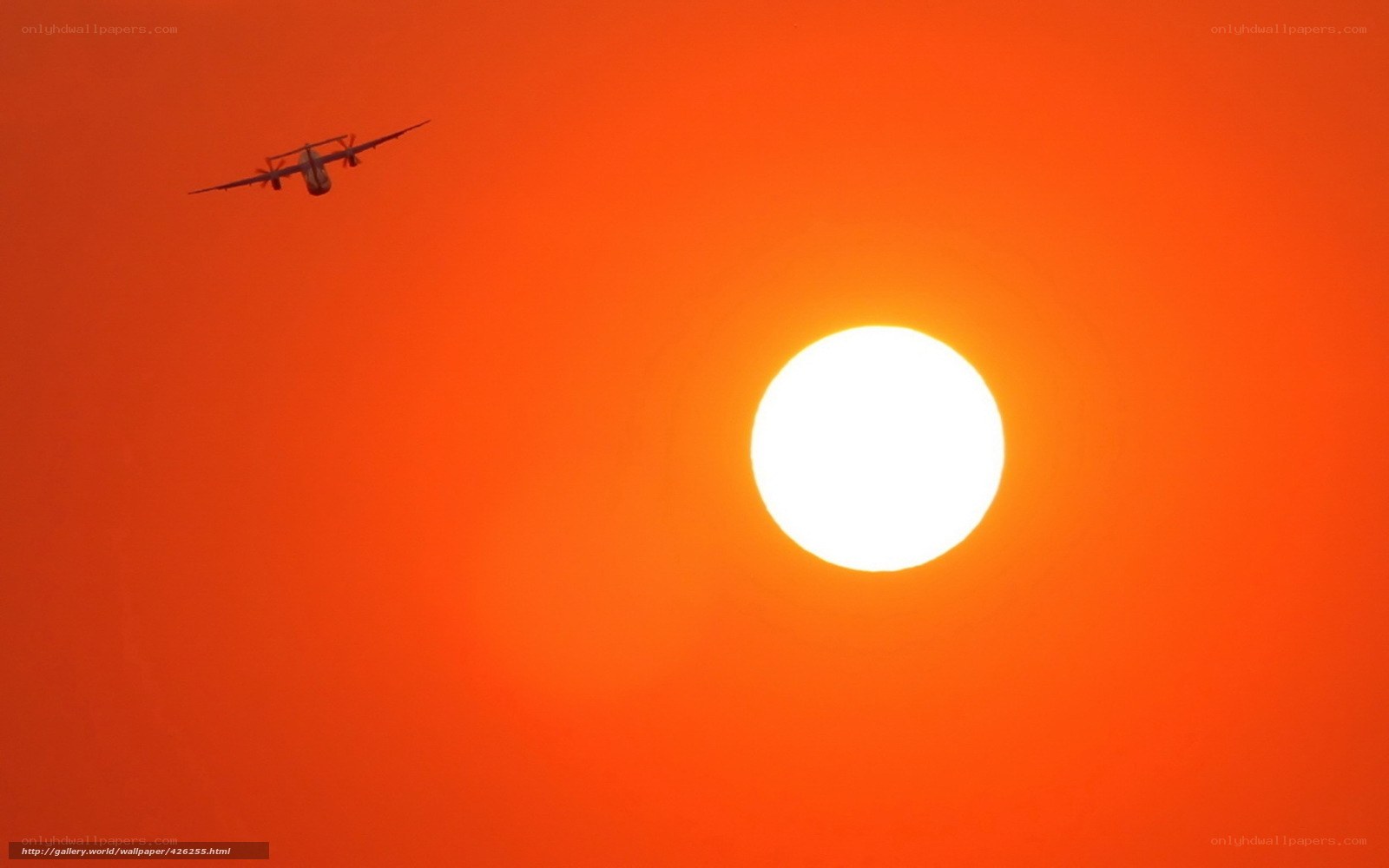 Airplane flying at sunset
