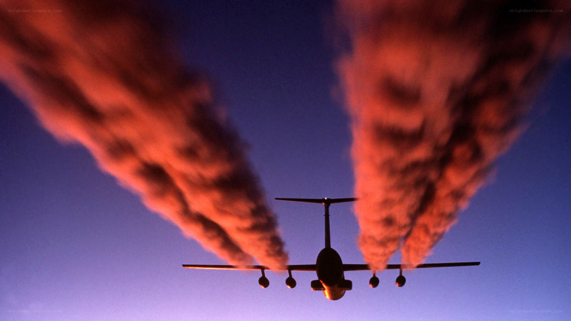airplane flying at sunset