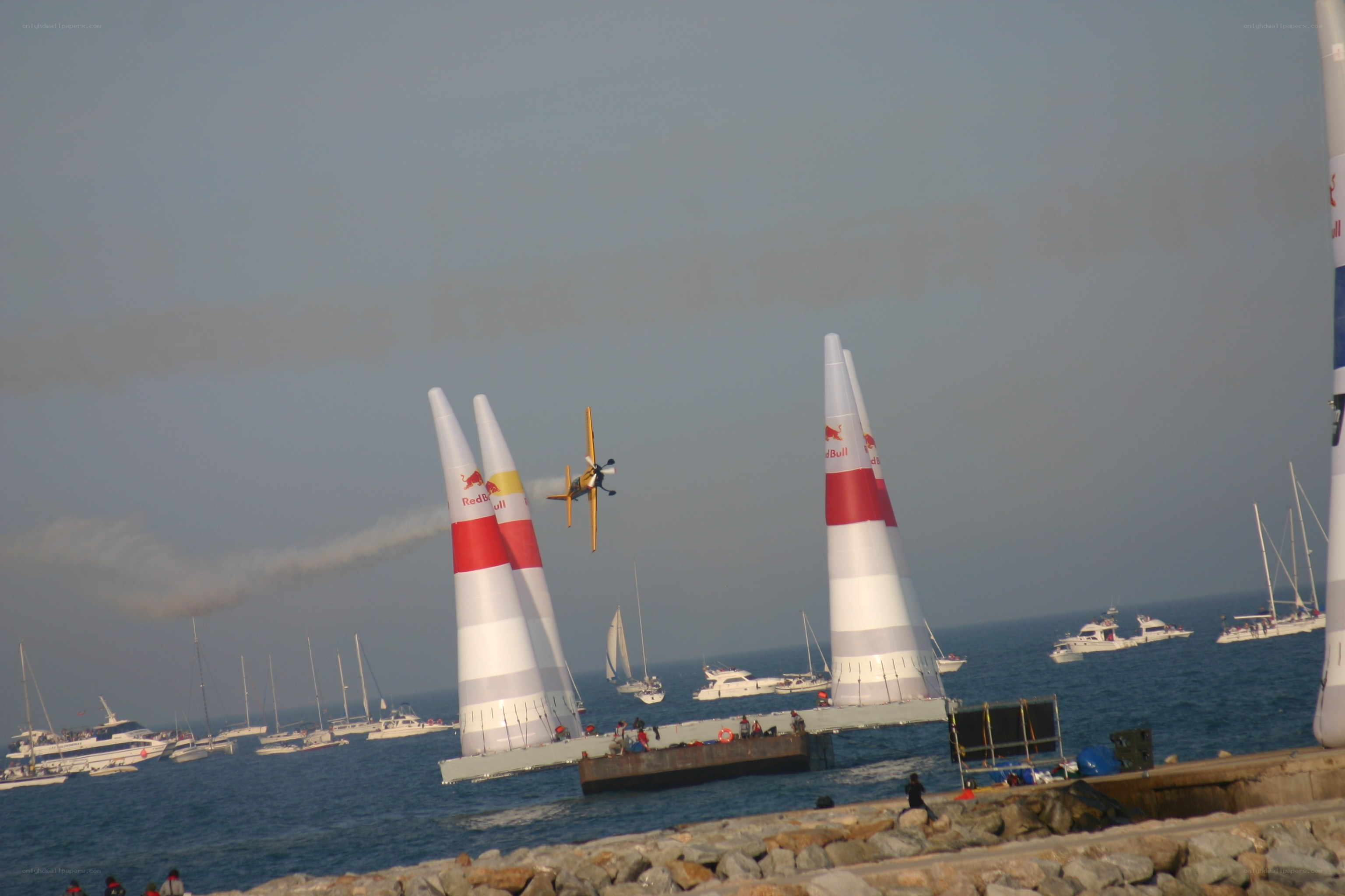 Airplane flying between Red Bull pylons