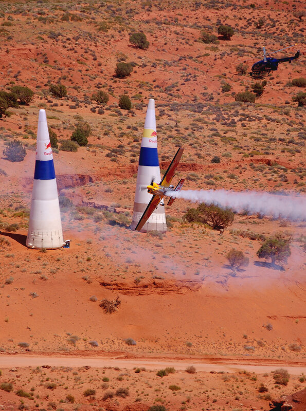 Airplane flying between Red Bull towers