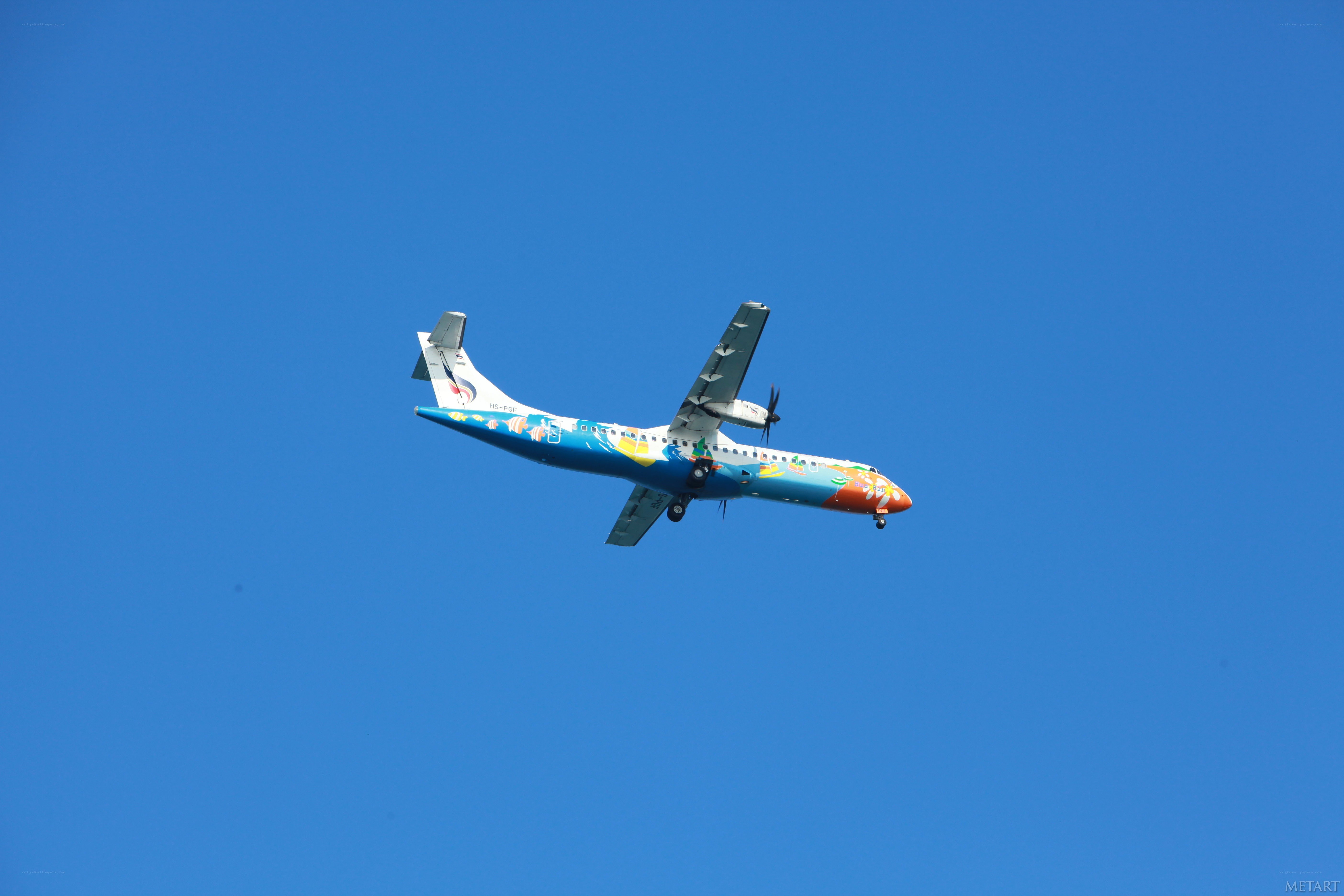 airplane flying in blue sky
