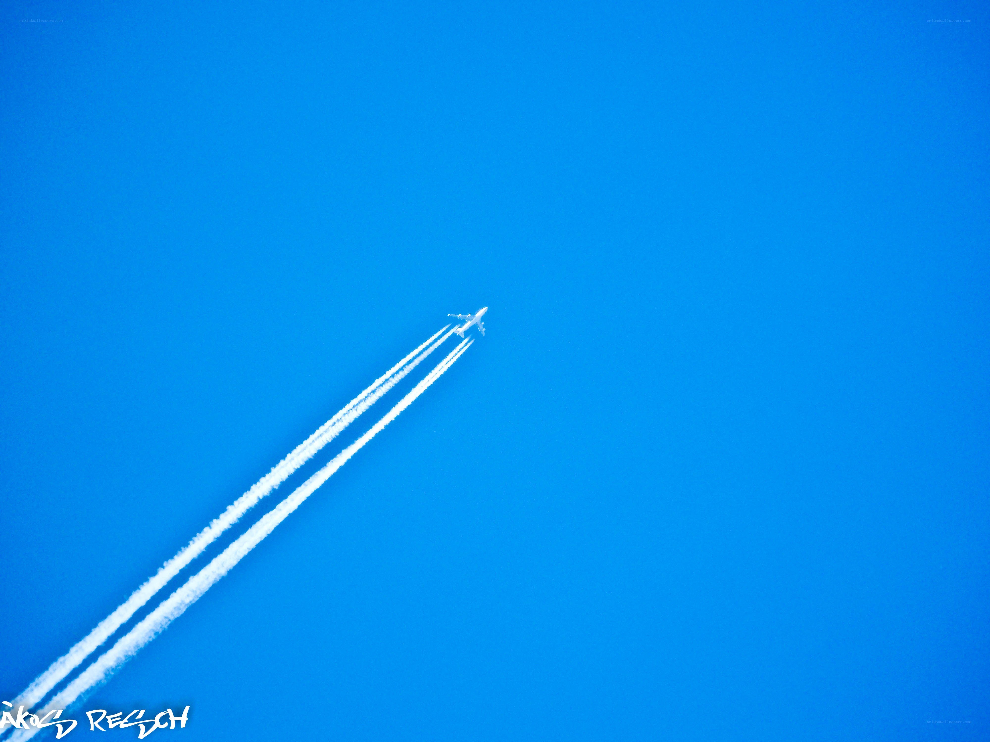 Airplane flying in blue sky