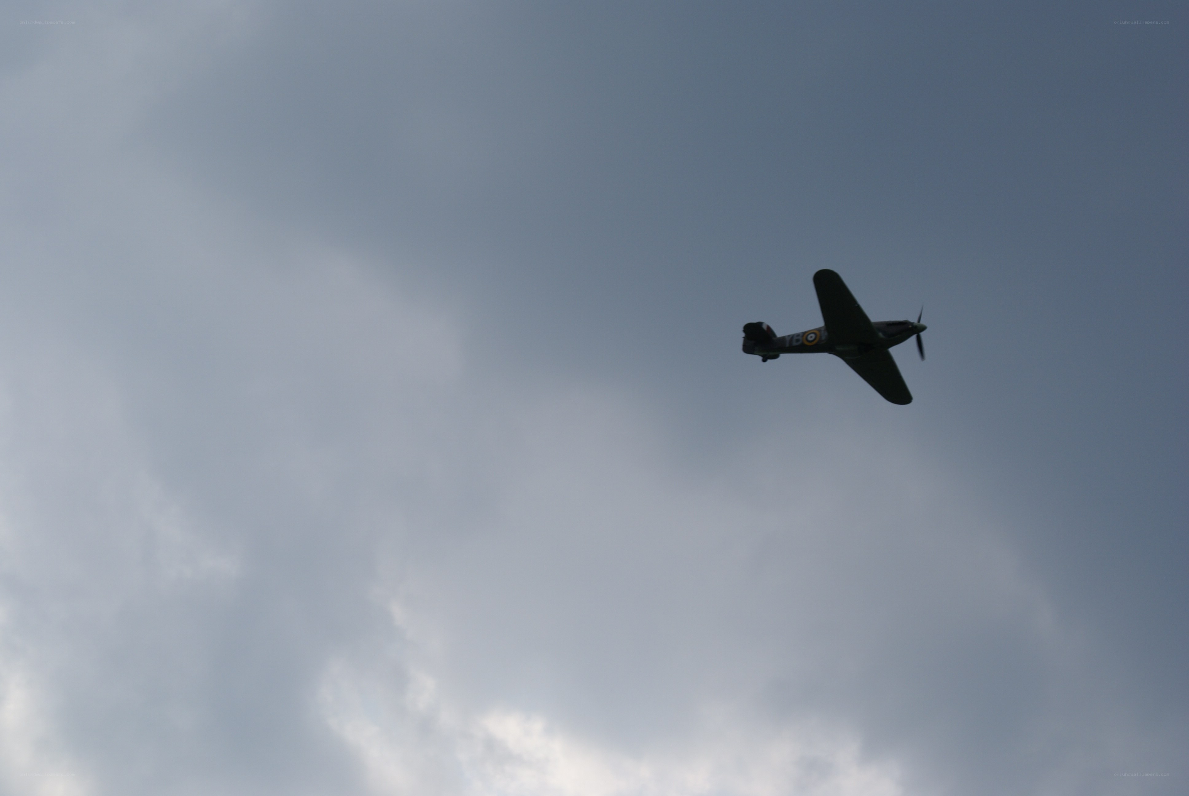 airplane flying in cloudy sky