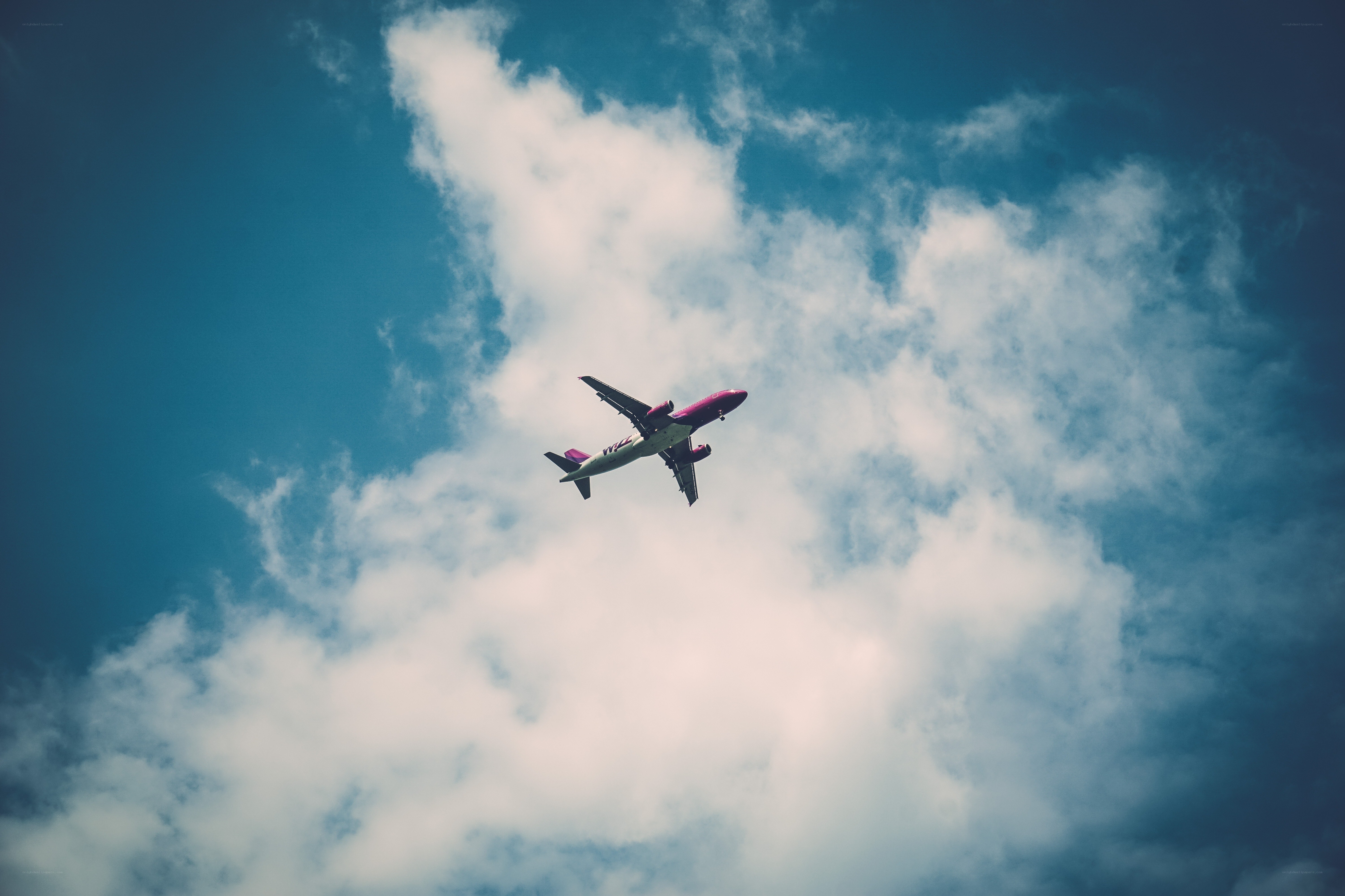 airplane flying in cloudy sky