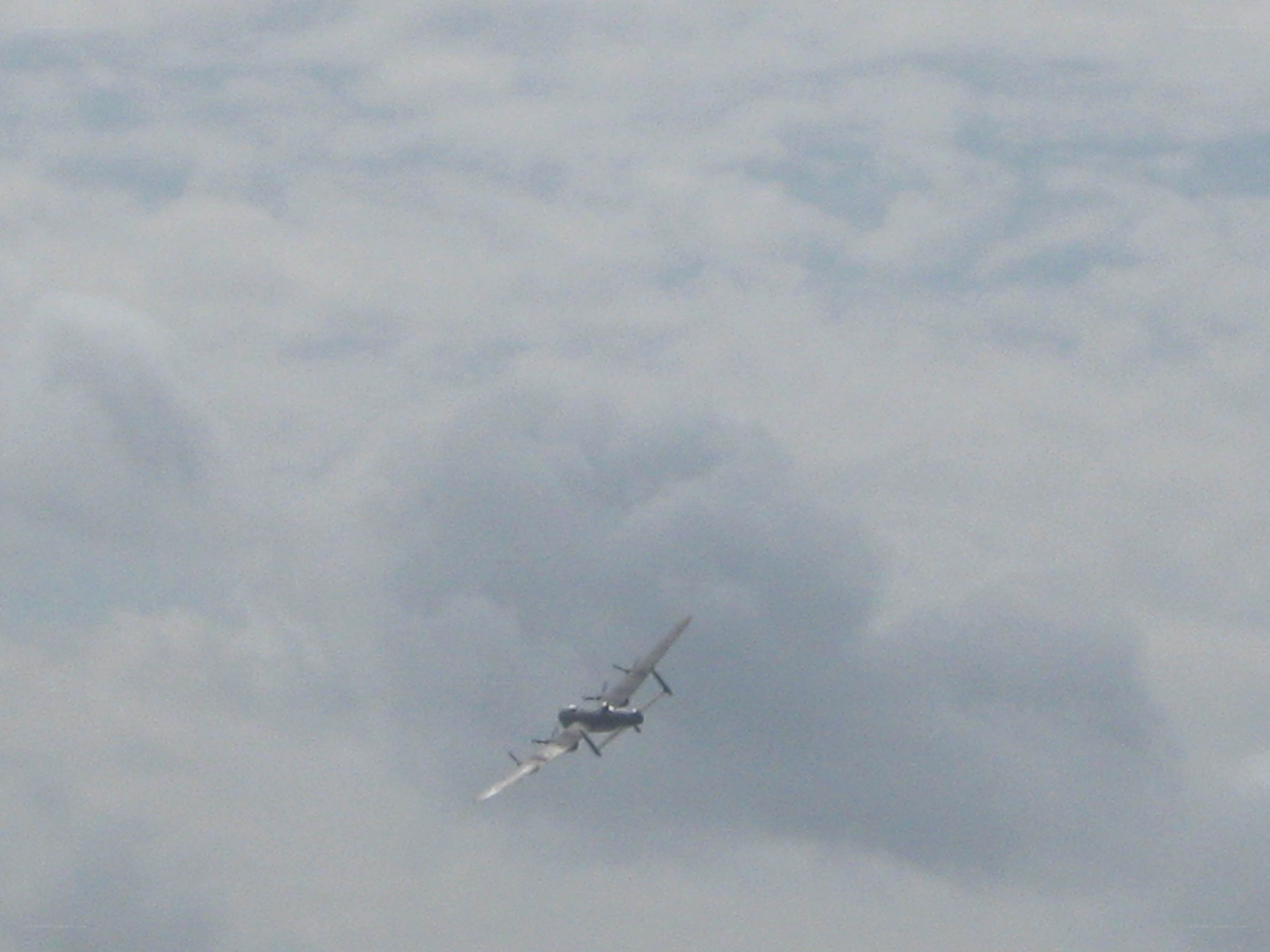 airplane flying in cloudy sky