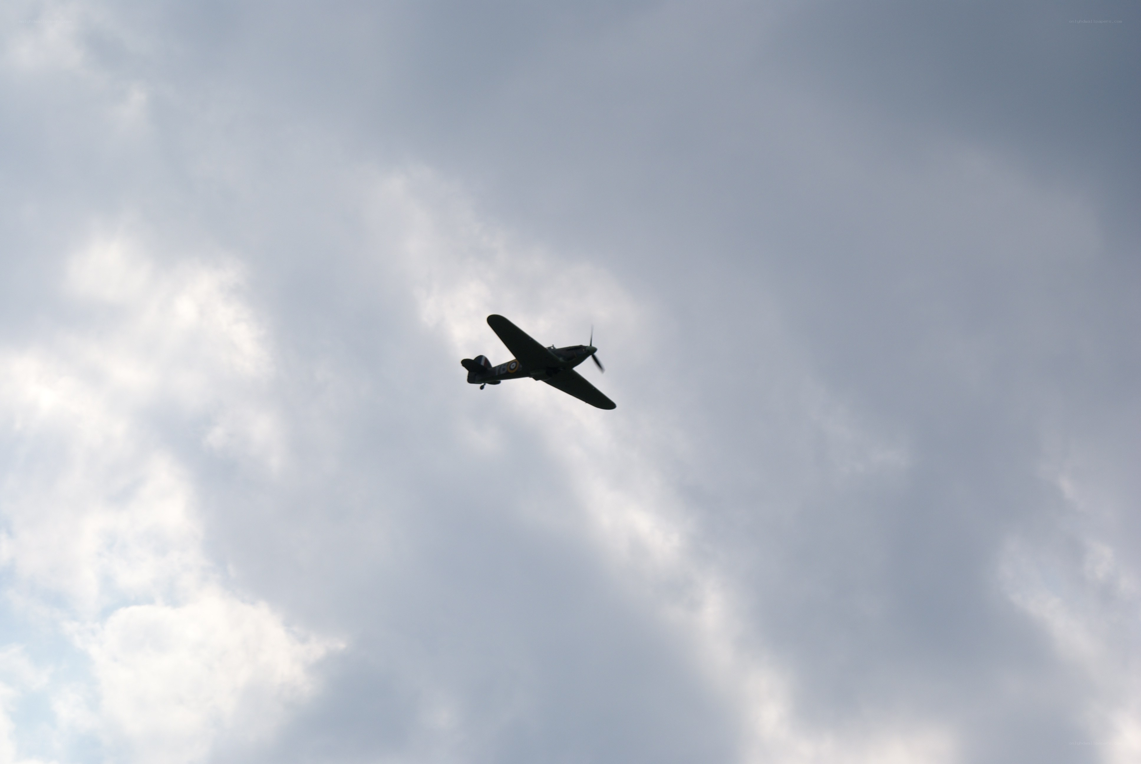 airplane flying in cloudy sky