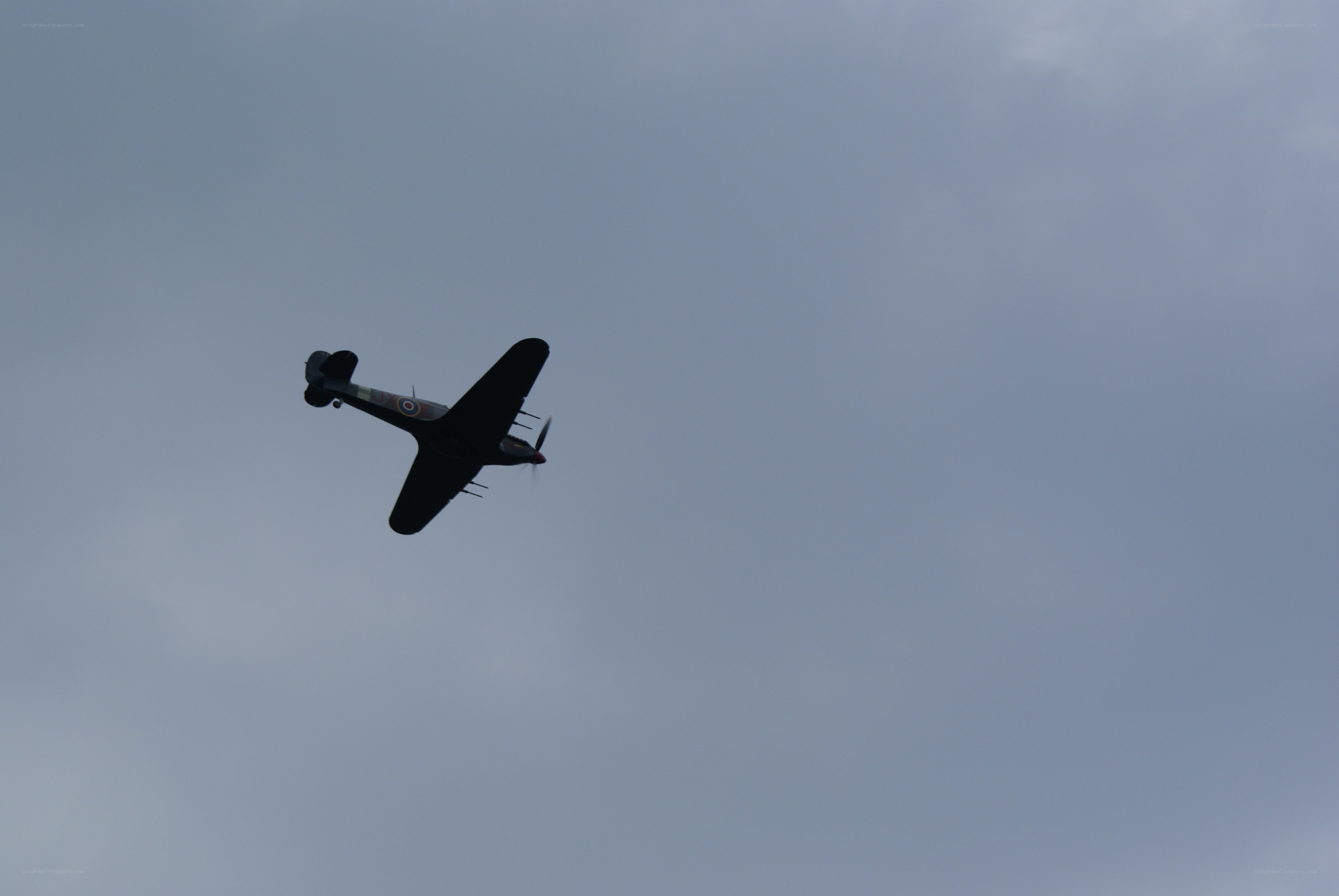 airplane flying in cloudy sky