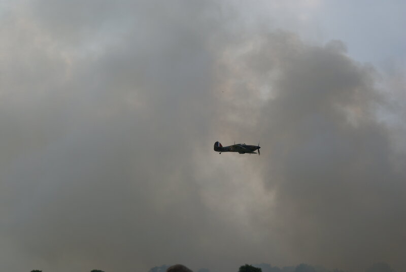 airplane flying in smoky sky