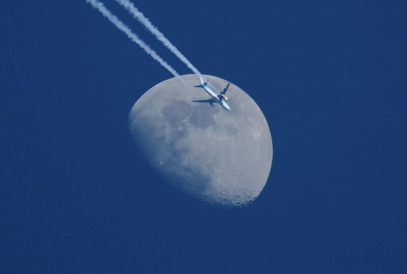 Airplane Flying Near Moon